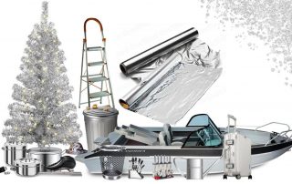 Aluminum Christmas tree surrounded by aluminum items such as a boat, cookware, ladder, aluminum foil