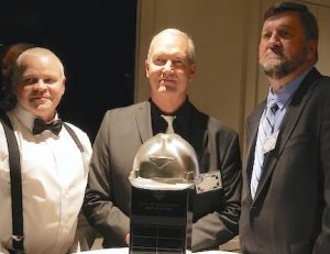 Russellville Plant Manager Gavin Buttherworth, Taber President Eric Angermeier, Gulfport and Plant Manager Mike Keenan standing by the NMLP Safety Award Trophy