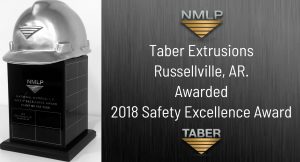 NMLP Safety Award image of a large black rectangular trophy with a silver hardhat on top donning the “NMLP inverted triangle” logo with the words “Taber Extrusions Awarded 2018 Safety Excellence Award.”