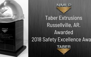 NMLP Safety Award image of a large black rectangular trophy with a silver hardhat on top donning the “NMLP inverted triangle” logo with the words “Taber Extrusions Awarded 2018 Safety Excellence Award.”
