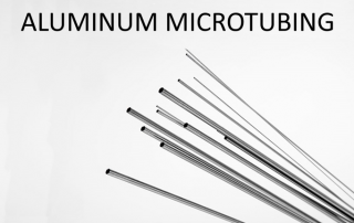 An edited image of a series of different sized microtubes with the words “Aluminum Microtubing.”