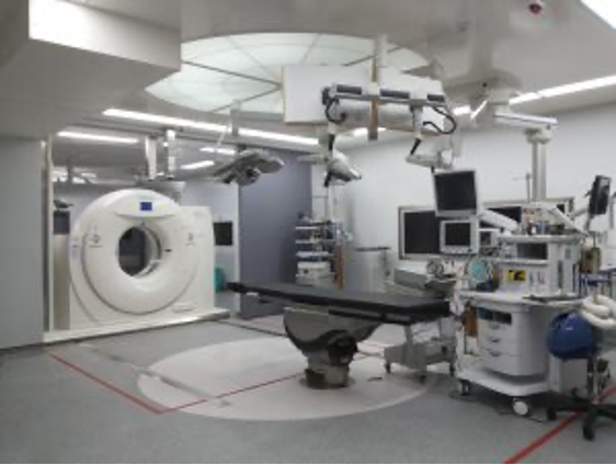 A brightly lit medical office containing an MRI machine and various other high tech medical testing equipment.