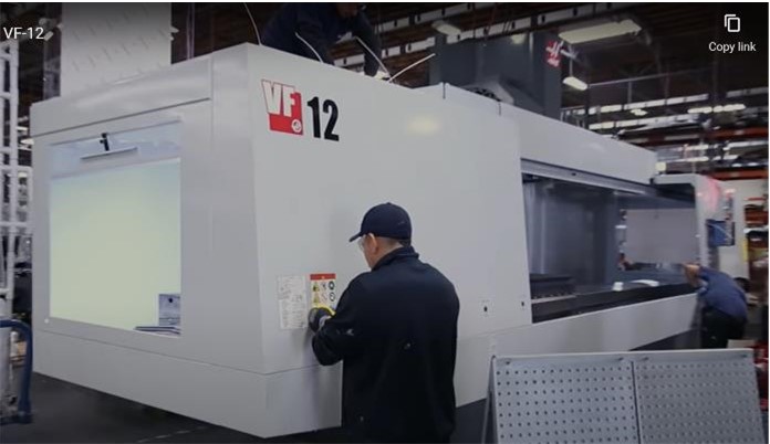 A CNC Machine being operated by two operators