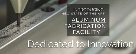 An extreme close-up photo of a CNC machine spindle with the words, “Introducing new state of the art aluminum fabrication facility – dedicated to innovation” in print on the right side.