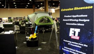 The Extrusion Showcase banner is on the right and the ET exhibitions are to the left in a hall. ET Showcase Image Attribution: https://www.aec.org/page/et22-showcase