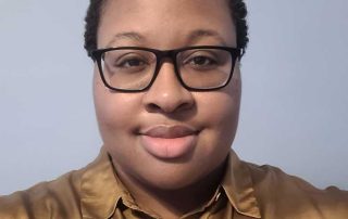 Headshot of Taber Extrusions' In Focus Spotlight Ashley Johnson, customer service rep: african-american woman with black framed triangular glasses