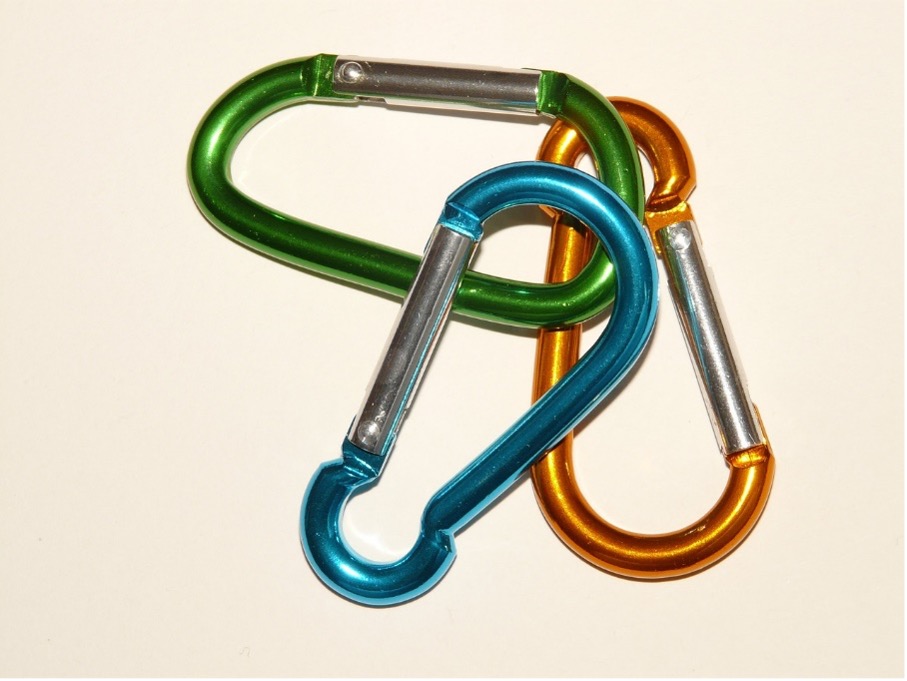 three aluminum carabiners colored green, blue and yellow