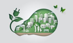 A graphic illustration of green city life inside an outline of a lightbulb with an outlet. On the top right are two green butterflies flying away.