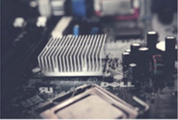 A heatsink nested on an exposed computer’s motherboard.