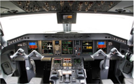 The interior of an airplane cockpit showcasing various screens and dashboard components.
