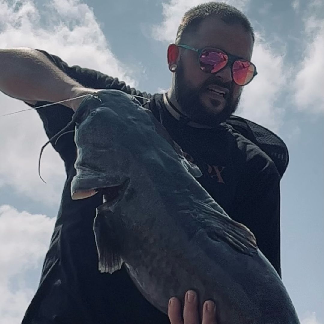 A photo of Regina Tramel's family member holding a fish.