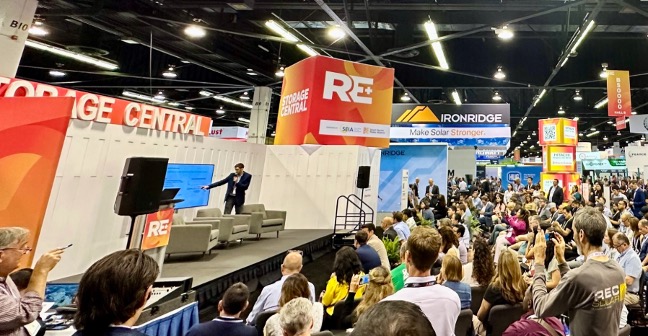 taber-blog-image-re-plus-event The RE+ 2025 venue with a speaker engaging with an audience in front of an enlarged event calendar.