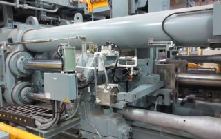 Massive 10,000-ton aluminum extrusion press demonstrating large-scale manufacturing capabilities for aerospace and defense applications.